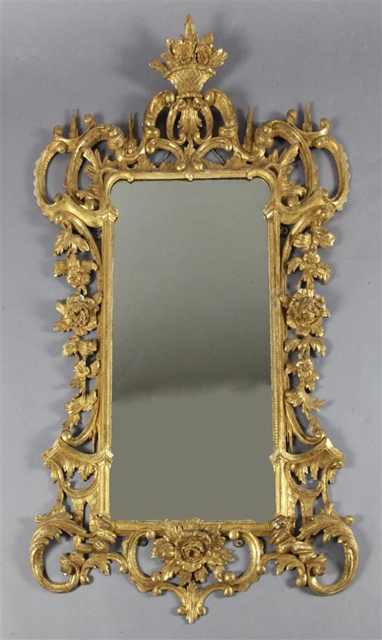 A late 19th century Chippendale style giltwood and gesso rococo carved wood wall mirror, 4ft 3in.